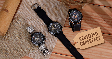 Four watches on a textured surface with a 'Certified Imperfect' tag.