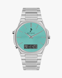 Silver watch with turquoise face and digital display on a white background