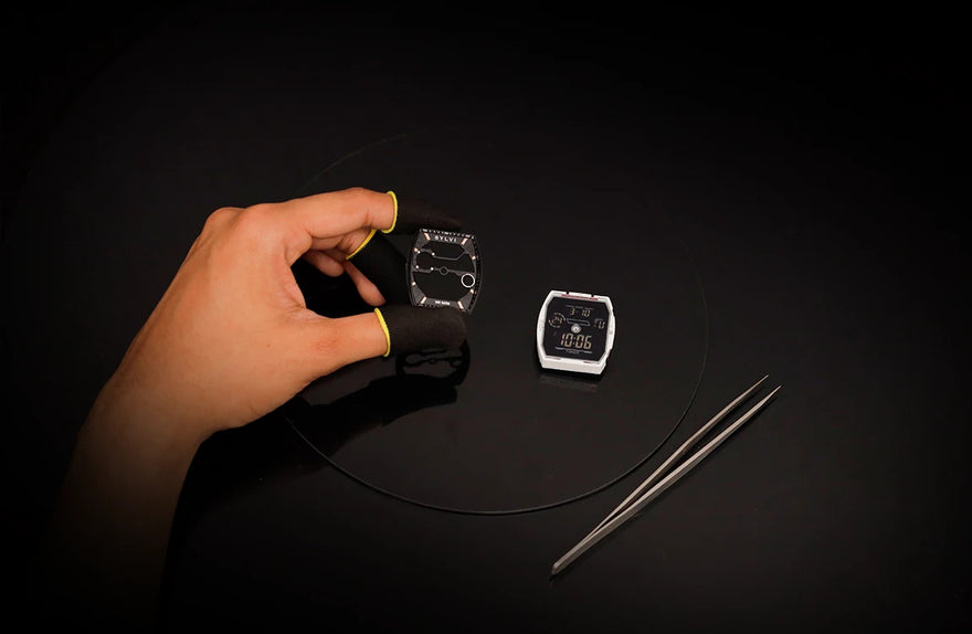 Sylvi Vanguard black rosegold silicone watch dial module being held during precision watch assembly