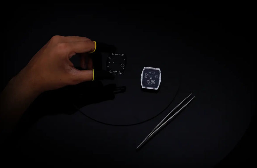 Sylvi Vanguard black silver silicone watch dial module held during precision watch assembly